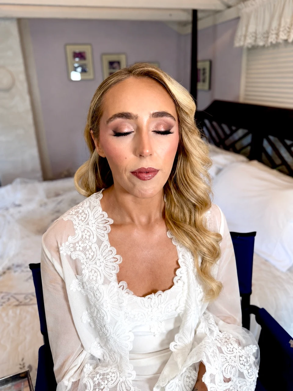 Close-up of a bride with shimmering eye makeup and blonde waves